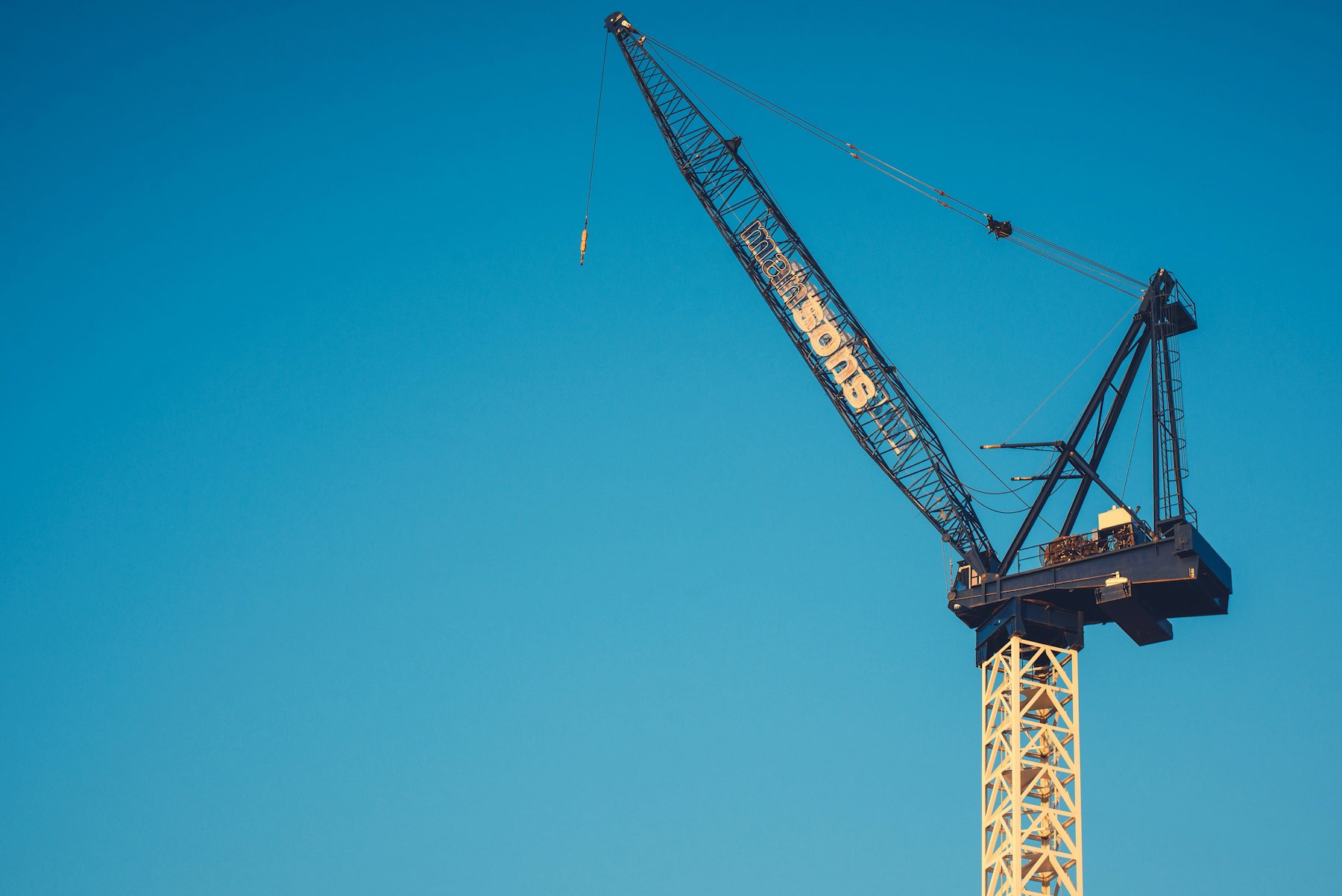 Heavy-lift crane against a clear blue sky