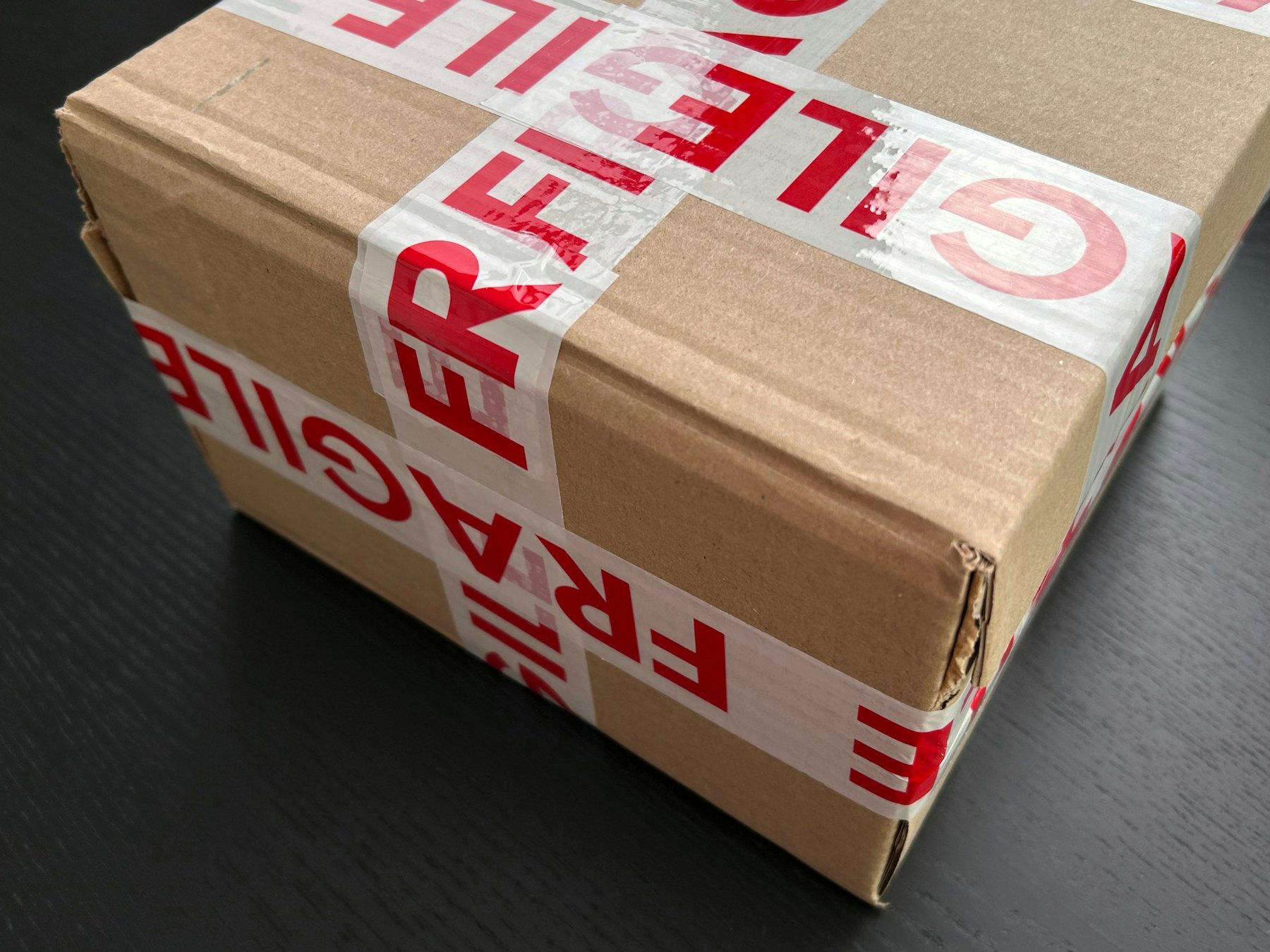 Carton sealed with fragile tape