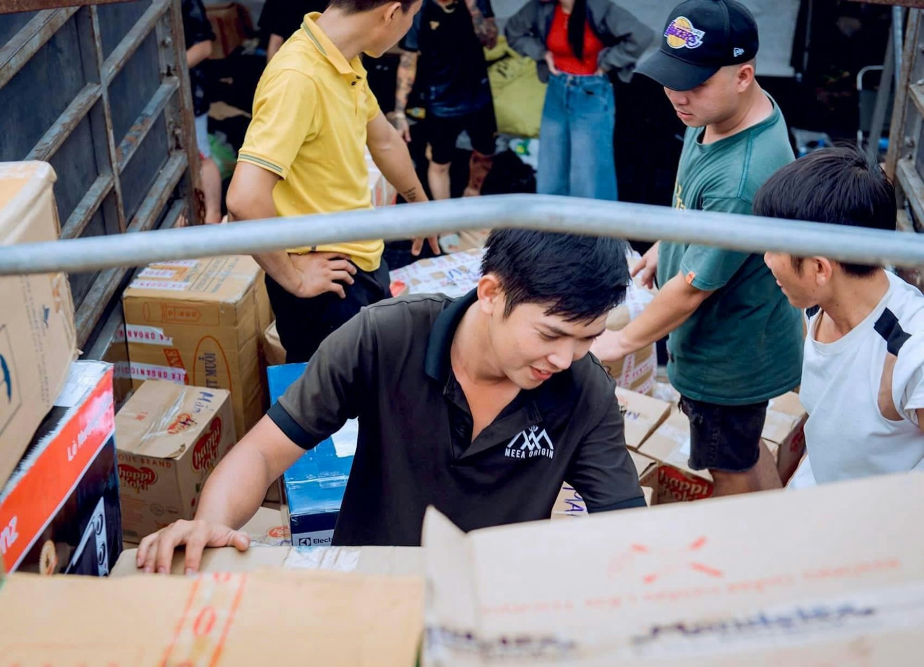 Team loading cartons into the back of a truck