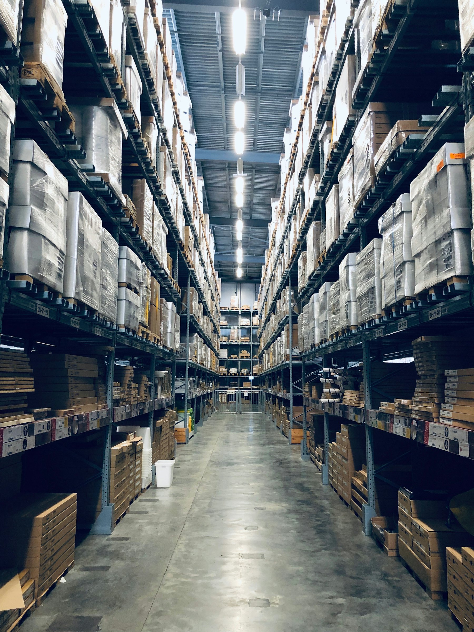 Tall racking filled with cartons in a warehouse aisle